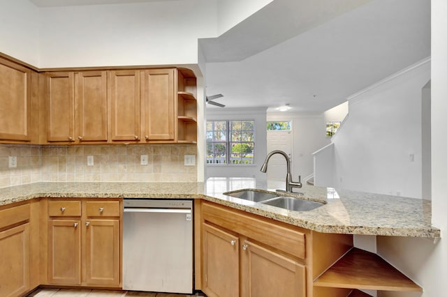 kitchen featuring open shelves, stainless steel dishwasher, a sink, light stone countertops, and a peninsula