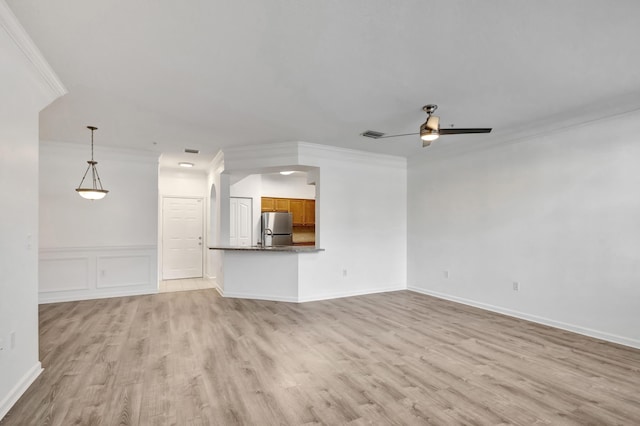 unfurnished living room with ceiling fan, ornamental molding, and light hardwood / wood-style flooring