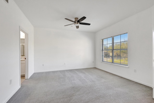 carpeted empty room featuring ceiling fan