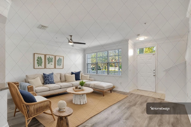 living area with visible vents and ceiling fan