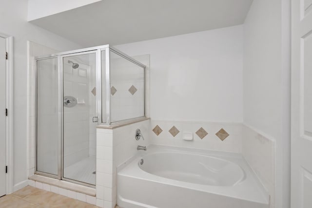 bathroom with a garden tub, tile patterned flooring, and a stall shower