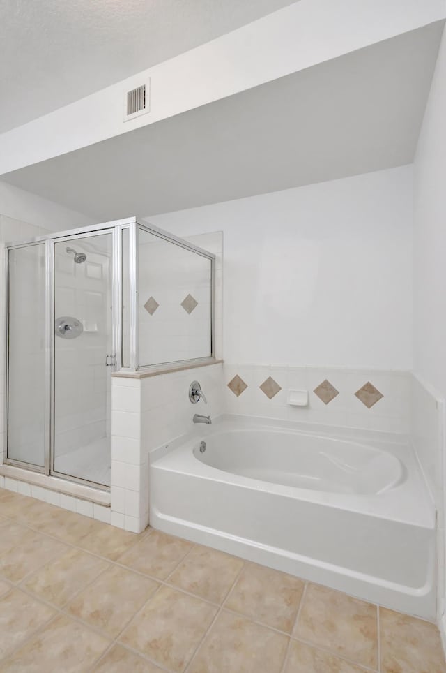 full bathroom with a shower stall, visible vents, tile patterned flooring, and a garden tub