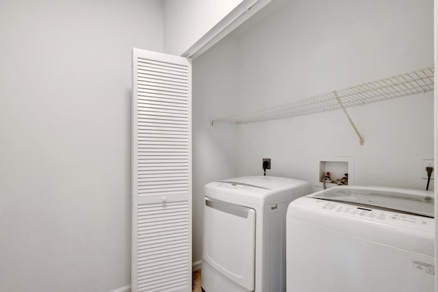 washroom with washing machine and clothes dryer and laundry area