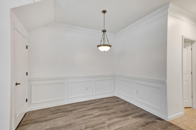 empty room featuring ornamental molding and light hardwood / wood-style floors