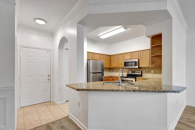 kitchen with sink, crown molding, stainless steel appliances, light stone countertops, and kitchen peninsula