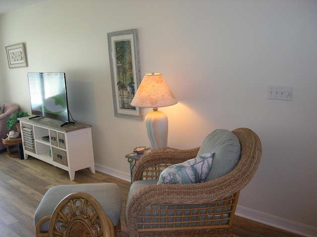 sitting room with hardwood / wood-style flooring