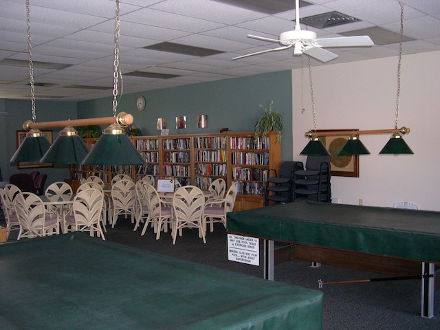 recreation room with ceiling fan, pool table, carpet, and a drop ceiling