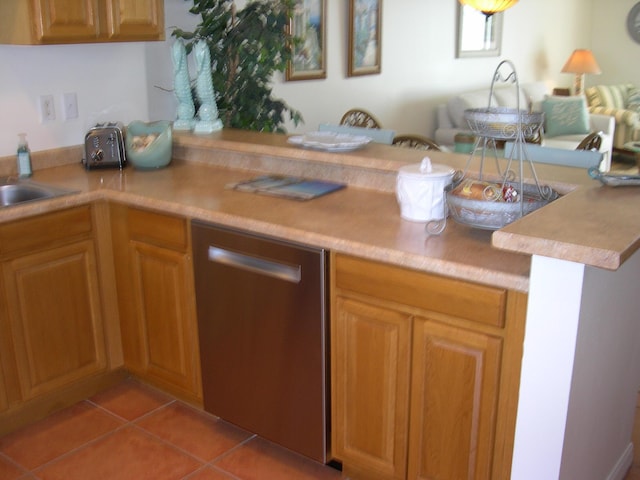 kitchen featuring light tile patterned flooring, dishwasher, and kitchen peninsula