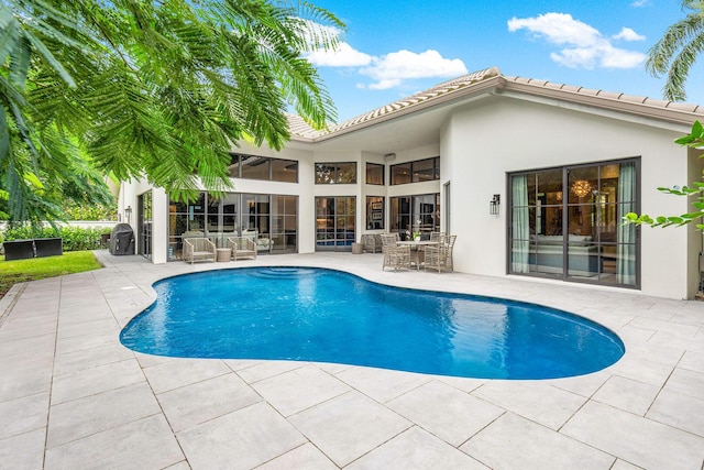 view of swimming pool with a patio area