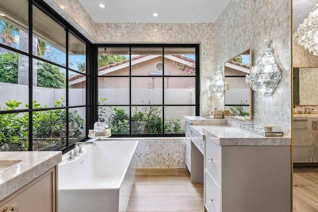 bathroom featuring vanity, a tub, and hardwood / wood-style floors