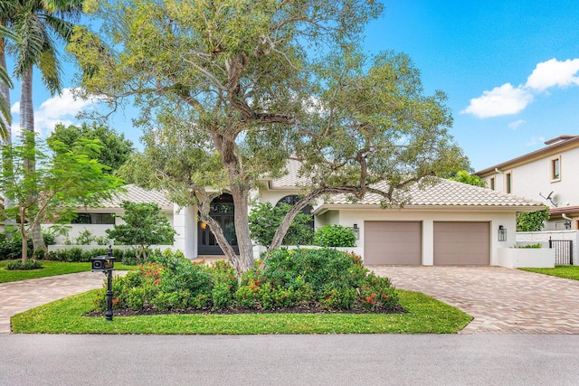 mediterranean / spanish home featuring a garage