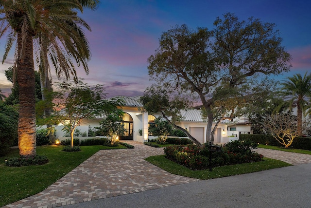 mediterranean / spanish home featuring a garage