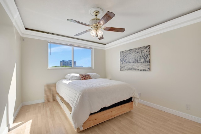 bedroom featuring crown molding, ceiling fan, and light wood-type flooring