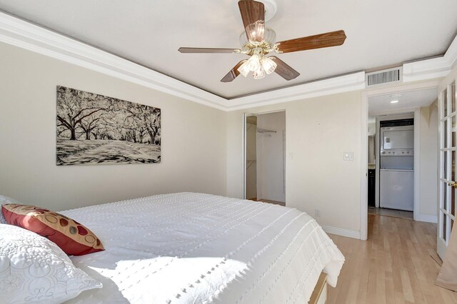 bedroom with ceiling fan, crown molding, and light wood-type flooring