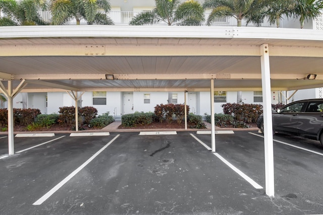 view of parking / parking lot featuring a carport