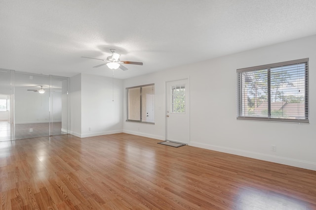 spare room featuring ceiling fan, a textured ceiling, and light hardwood / wood-style floors