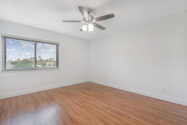 unfurnished room featuring ceiling fan, a textured ceiling, and light wood-type flooring