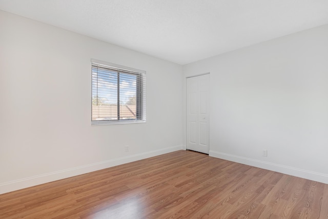 empty room with light hardwood / wood-style floors