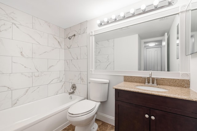 full bathroom featuring tiled shower / bath, vanity, and toilet