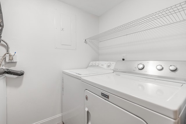 clothes washing area featuring washing machine and clothes dryer and electric panel