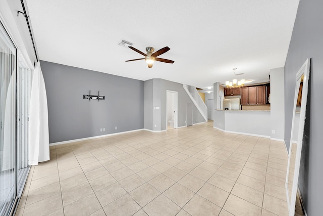 unfurnished living room featuring light tile patterned flooring and ceiling fan with notable chandelier