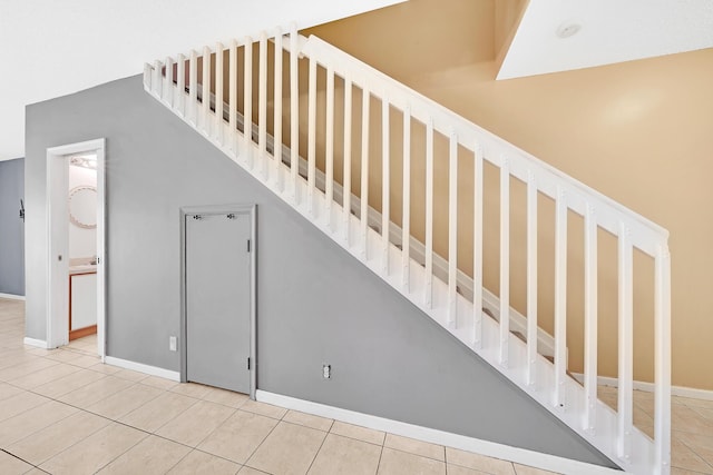 staircase featuring tile patterned flooring