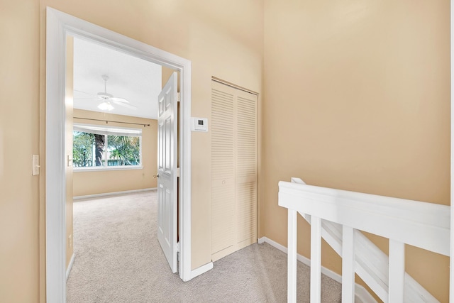 corridor featuring light colored carpet