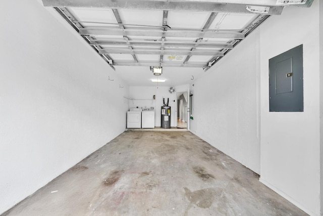 garage with water heater, washing machine and dryer, a garage door opener, and electric panel