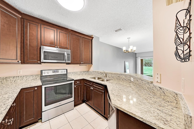 kitchen featuring sink, appliances with stainless steel finishes, light stone countertops, a textured ceiling, and light tile patterned flooring