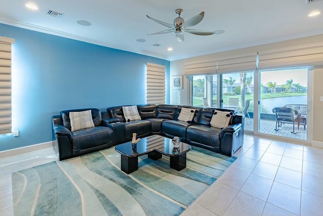 living area featuring tile patterned floors, visible vents, baseboards, and ornamental molding