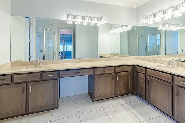 bathroom with a sink, marble finish floor, a stall shower, and crown molding