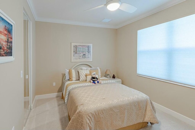 bedroom featuring light colored carpet, crown molding, baseboards, and ceiling fan