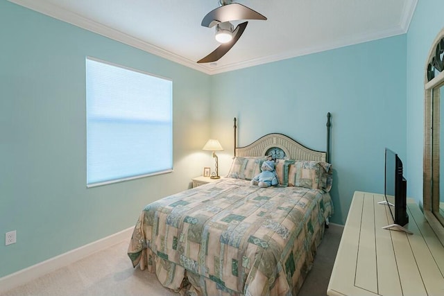 carpeted bedroom featuring ceiling fan, baseboards, and ornamental molding