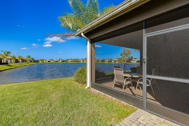 view of yard with a water view and a sunroom