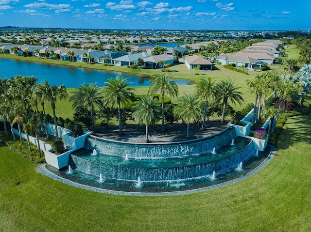 exterior space with a lawn, a residential view, and a water view