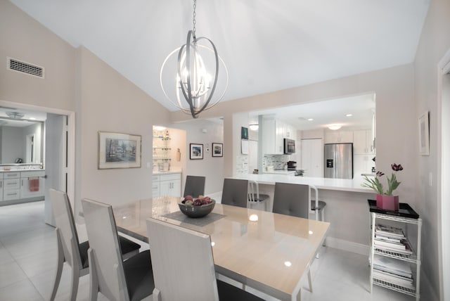 dining room featuring light tile patterned flooring, visible vents, vaulted ceiling, and an inviting chandelier