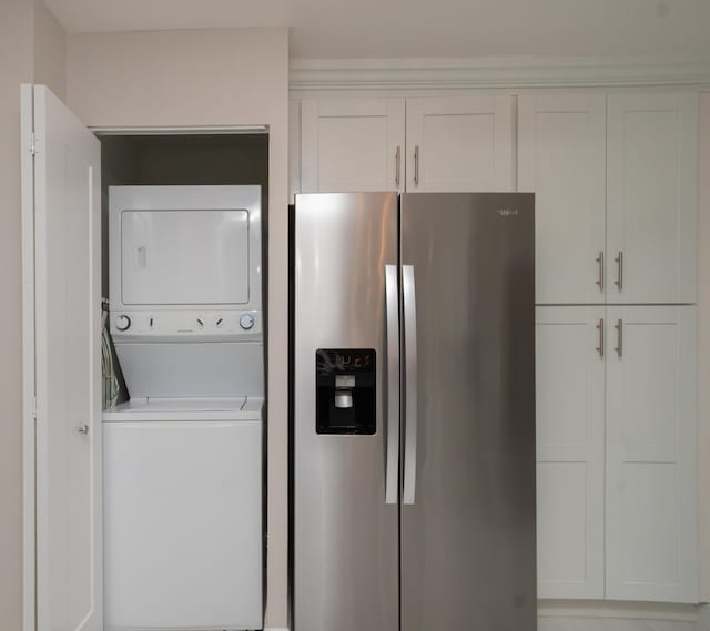 clothes washing area featuring laundry area and stacked washer / drying machine