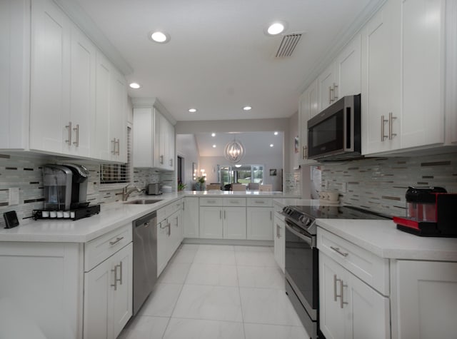 kitchen featuring light countertops, appliances with stainless steel finishes, a sink, and white cabinetry