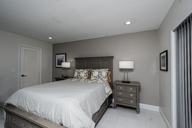 bedroom with a textured ceiling, marble finish floor, recessed lighting, and baseboards