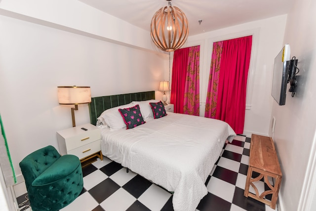 bedroom with a notable chandelier