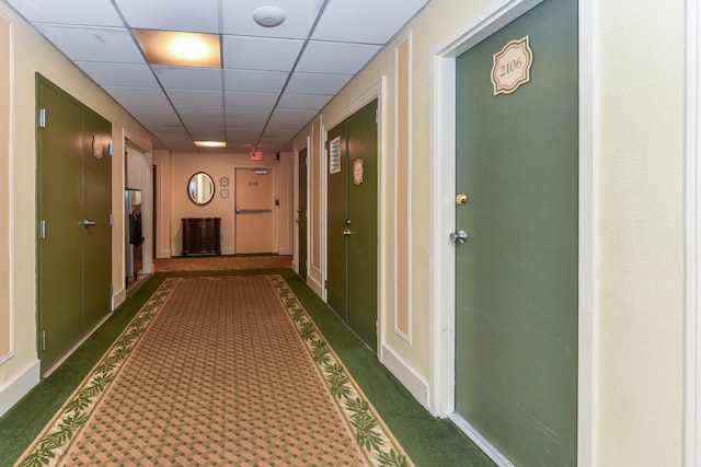 hall featuring a paneled ceiling