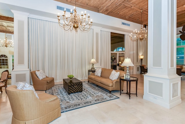 living room featuring beam ceiling, a chandelier, decorative columns, and wooden ceiling