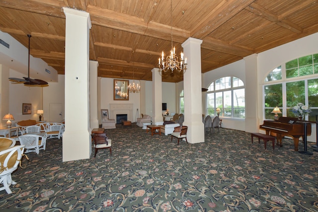 interior space with ceiling fan with notable chandelier, wooden ceiling, beamed ceiling, and ornate columns