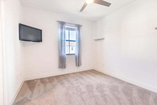 empty room featuring light carpet and ceiling fan