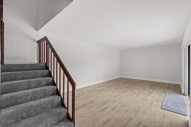 stairs featuring wood-type flooring