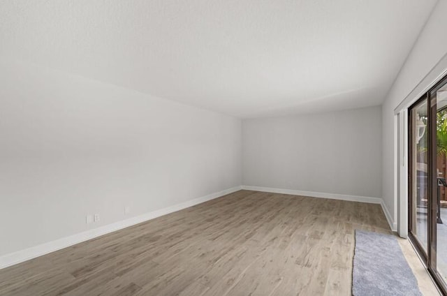 unfurnished room with light hardwood / wood-style flooring