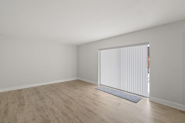 spare room with light hardwood / wood-style floors