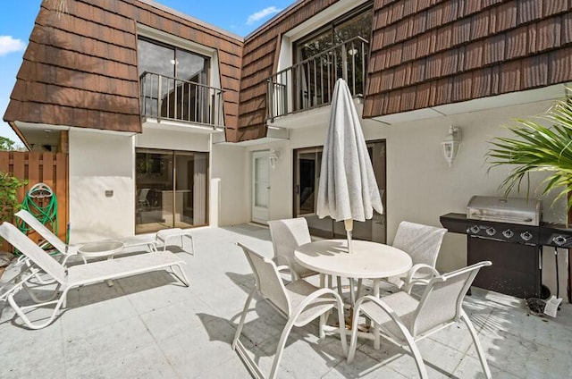 view of patio with a balcony and grilling area