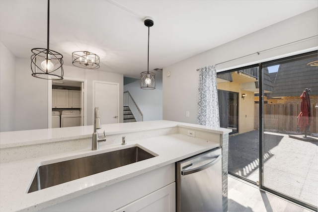 kitchen featuring pendant lighting, sink, light stone counters, and stainless steel dishwasher