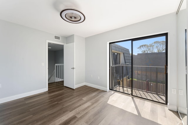 unfurnished room with hardwood / wood-style floors